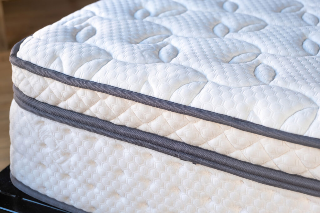 Mattress on a bed close up. Home bedroom interior detail, high a